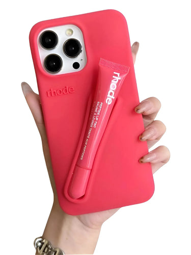 Deep Pink silicone lipstick iPhone case with a lip balm holder labeled 'rhode' held by a hand.
